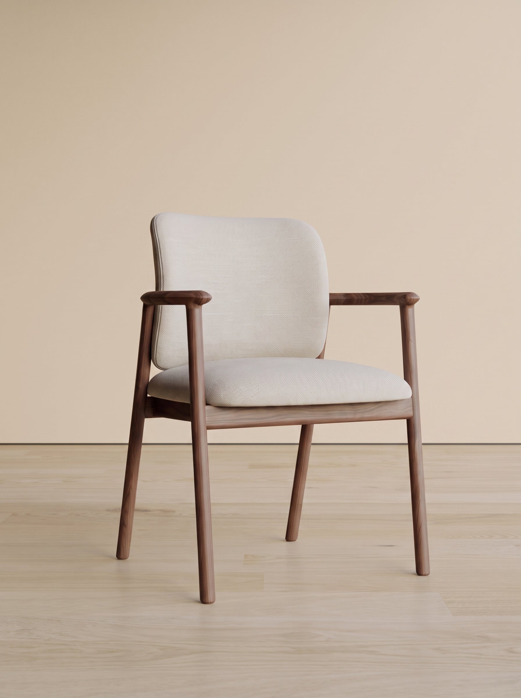 A mid-century modern armchair with a light beige upholstered seat and backrest, supported by a warm brown wooden frame, set against a minimalist beige wall and light wood floor.